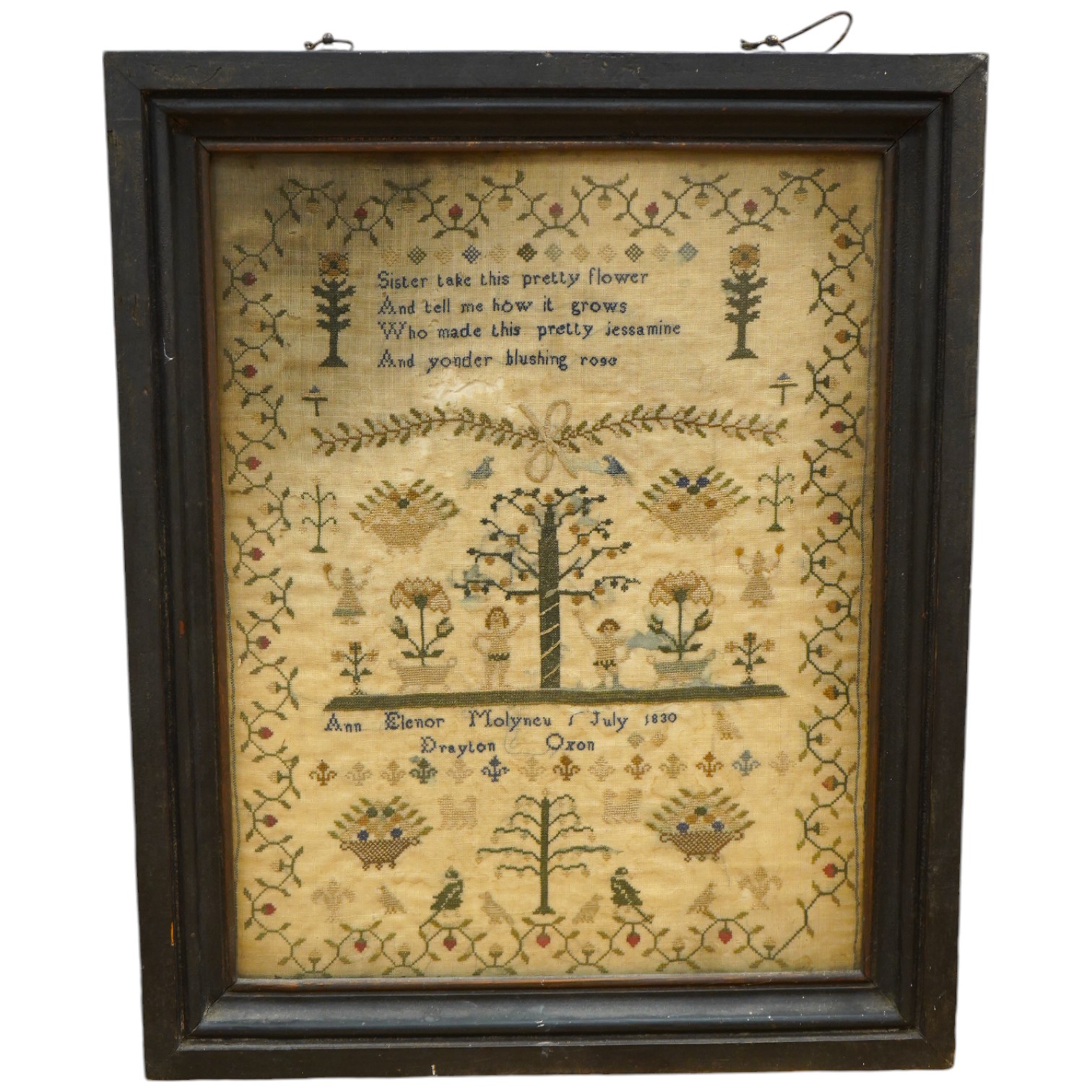 A framed Adam and Eve finely embroidered sampler, by Ann Elenor Molyneu, dated July 1830, Drayton, Oxon, embroidered on fine linen with multi-coloured silks and geometric stylistic floral border, with a short verse above